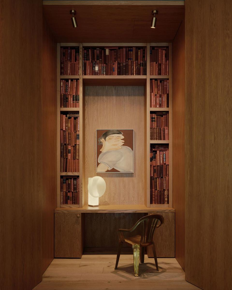 a bookcase with a chair and a table in front of it