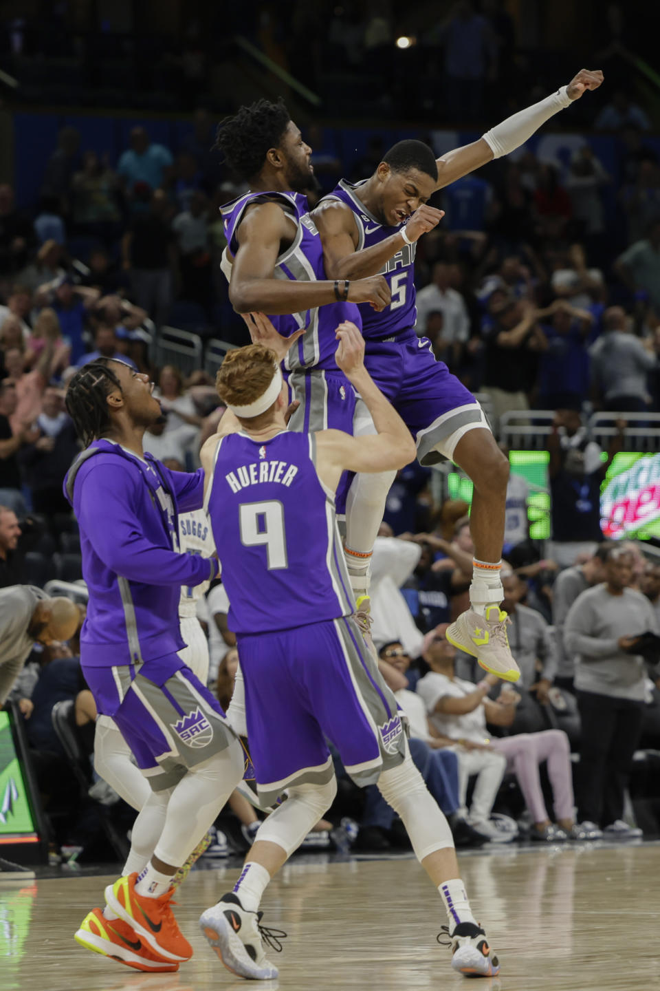 Sacramento Kings guard De'Aaron Fox (5) celebrates with his team after his 3-point final shot against the Orlando Magic during overtime of an NBA basketball game, Saturday, Nov. 5, 2022, in Orlando, Fla. (AP Photo/Kevin Kolczynski)