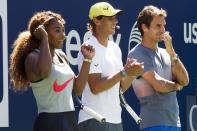 FILE - Serena Williams, Rafael Nadal and Roger Federer, right, cheer on the competition during Arthur Ashe Kids' Day, the kick off to the U.S. Open tennis tournament, Aug. 24, 2013, in New York. Some older fans in particular — middle-aged, or beyond — said they saw in Williams’ latest run at the 2022 U.S. Open a very human and relatable takeaway. Namely the idea that they, also, could perform better and longer than they once thought possible — through fitness, practice and grit. (Photo by Charles Sykes/Invision/AP, File)