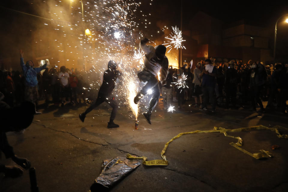 Protesters set off fireworks as a fire burns at the Minneapolis police 3rd Precinct building, May 28, following the police killing of George Floyd. (Photo: ASSOCIATED PRESS)