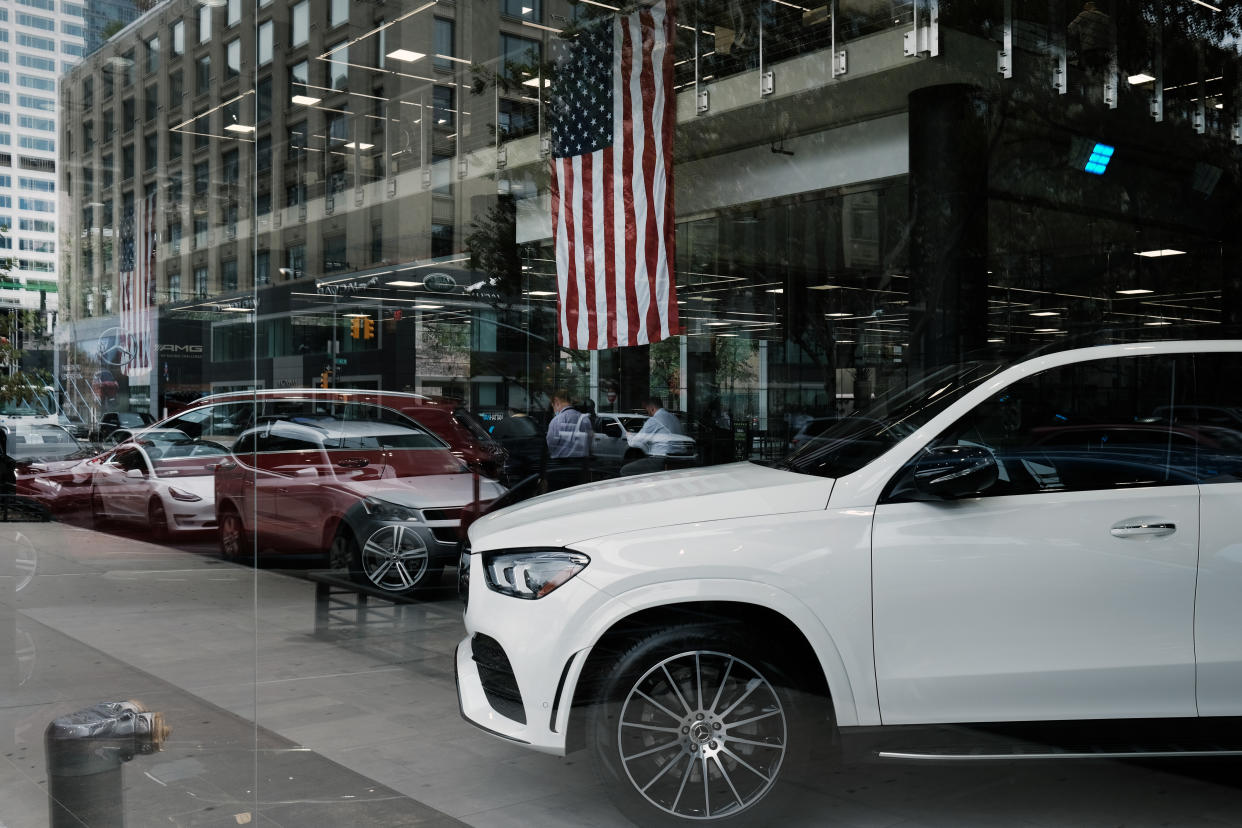 NEW YORK, NEW YORK - OCTOBER 05: New cars are showcased in the window of a car dealership on October 05, 2021 in New York City. As chip shortages and other parts-supply disruptions upend the auto industry, new vehicle sales fell nearly 26% in September in the United States. A limited selection of new vehicles on dealer’s lots is leading to consumer frustration and a surge in the price of used vehicles. For the third quarter, auto sales were 3.4 million, down 13% from the same period a year ago. (Photo by Spencer Platt/Getty Images)