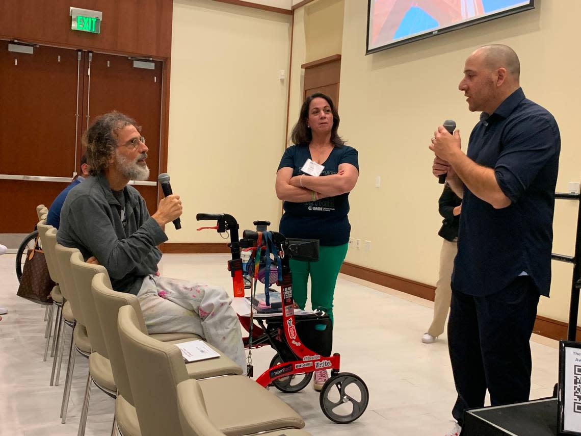 Kevin Hines, right, speaks with an attendee at NAMI Miami-Dade’s first South Florida Suicide Awareness conference at the University of Miami on Saturday, March 4, 2023. Hines tried to die by suicide in 2000 at the age of 19. He jumped off the Golden Gate Bridge in San Francisco and survived. He is now a suicide prevention speaker.