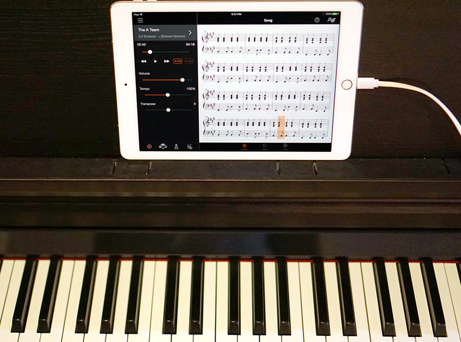 The iPad connects to the piano to display the sheet music for any song.