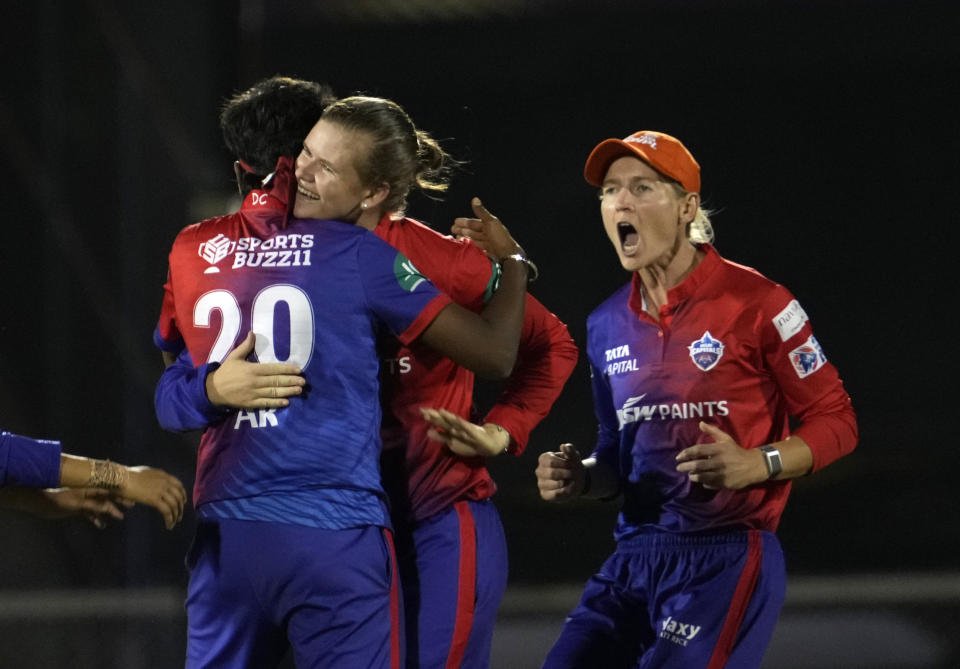 Delhi Capitals Jess Jonassen, centre, and Meg Lanning, right, celebrate the dismissal of Mumbai Indians Hayley Matthews during during the Women's Premier League Twenty20 cricket final match between Delhi Captials and Mumbai Indians in Mumbai, India, Sunday, March 26, 2023. (AP Photo/Rajanish Kakade)