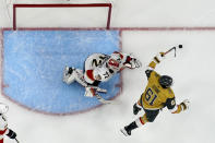 Vegas Golden Knights right wing Mark Stone (61) celebrates the goal of teammate Jonathan Marchessault during the first period of Game 2 of the NHL hockey Stanley Cup Finals as Florida Panthers goaltender Sergei Bobrovsky (72) looks on, Monday, June 5, 2023, in Las Vegas. (AP Photo/John Locher)