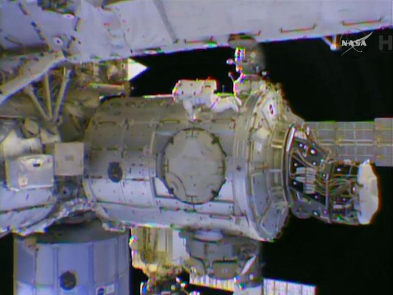 Astronaut Terry Virts (C) steps out on the second of three spacewalks to prepare the International Space Station, on Febuary 25, 2015