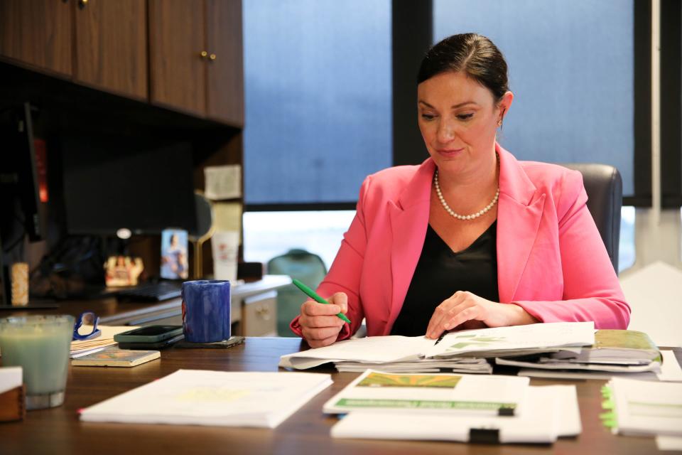 Adria Berry, executive director of the Oklahoma Medical Marijuana Authority, reviews documents June 12 at her office in Oklahoma City.