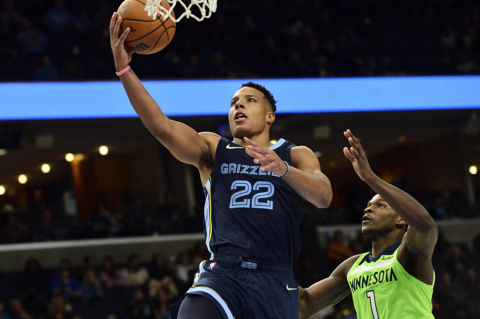 Memphis Grizzlies guard Desmond Bane (22) shoots ahead of Minnesota Timberwolves forward Anthony Edwards (1) in the second half of an NBA basketball game, Monday, Nov. 8, 2021, in Memphis, Tenn. (AP Photo/Brandon Dill)