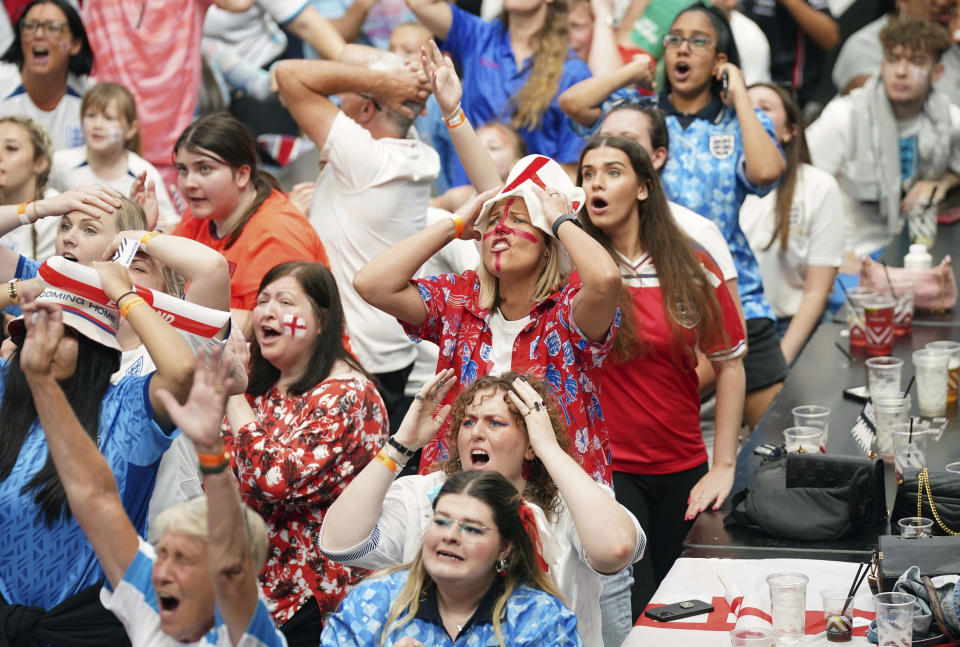 England fans react as they watch a screening of the Women's World Cup final between England and Spain at BOXPARK Wembley, London, Sunday Aug. 20, 2023. (Lucy North/PA via AP)
