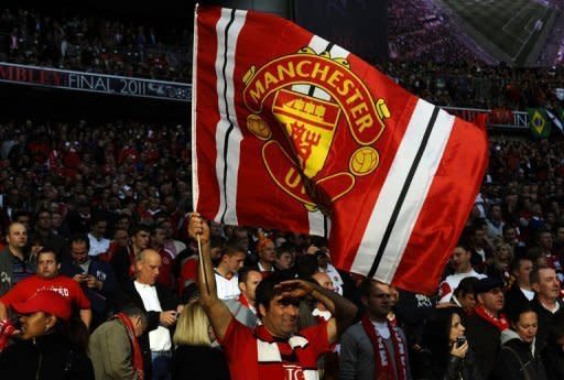 Manchester United's supporters cheer their team prior to a match in May 2011. Legendary English football club Manchester United plan to tap their massive Asian fan base with a lucrative share listing in Singapore this year, sources familiar with the deal confirmed Wednesday