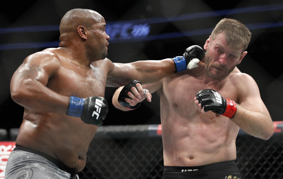 Daniel Cormier punches Stipe Miocic during a heavyweight title bout in 2018. (AP Photo/John Locher)