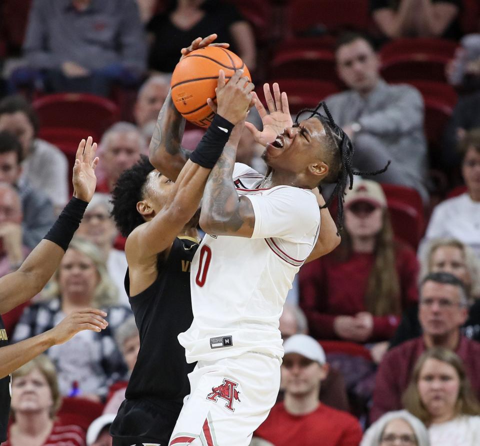 Feb 27, 2024; Fayetteville, Arkansas, USA; Vanderbilt Commodores guard Tyrin Lawrence (0) defends against Arkansas Razorbacks guard Khalif Battle (0) during the first half at Bud Walton Arena. Mandatory Credit: Nelson Chenault-USA TODAY Sports