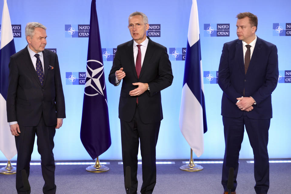 NATO Secretary General Jens Stoltenberg, center, addresses a media conference with Finland's Defense Minister Antti Kaikkonen, right, and Finland's Foreign Minister Pekka Haavisto, left, at NATO headquarters in Brussels on Monday, March 20, 2023. (AP Photo/Olivier Matthys)