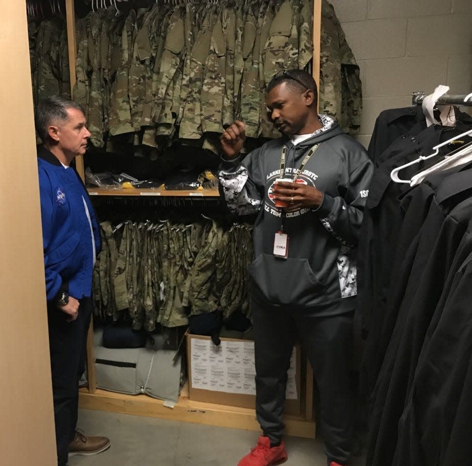 JROTC instructor Sgt. Antione Clark, right, shows astronaut Shane Kimbrough the various uniforms the cadets wear at Clarke Central High School on Friday, Nov. 18, 2022.