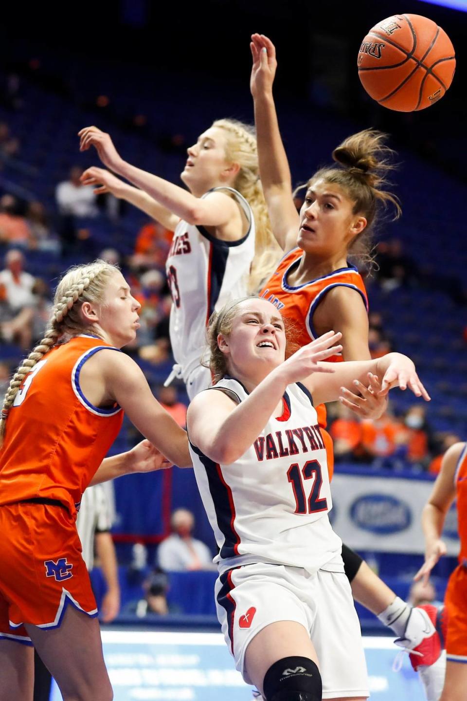 Marshall County’s Jada Driver (3) and Sophie Galloway (32) battle Sacred Heart’s Josie Gilvin (33) and Claire Russell (12) for a rebound during Saturday’s state finals.