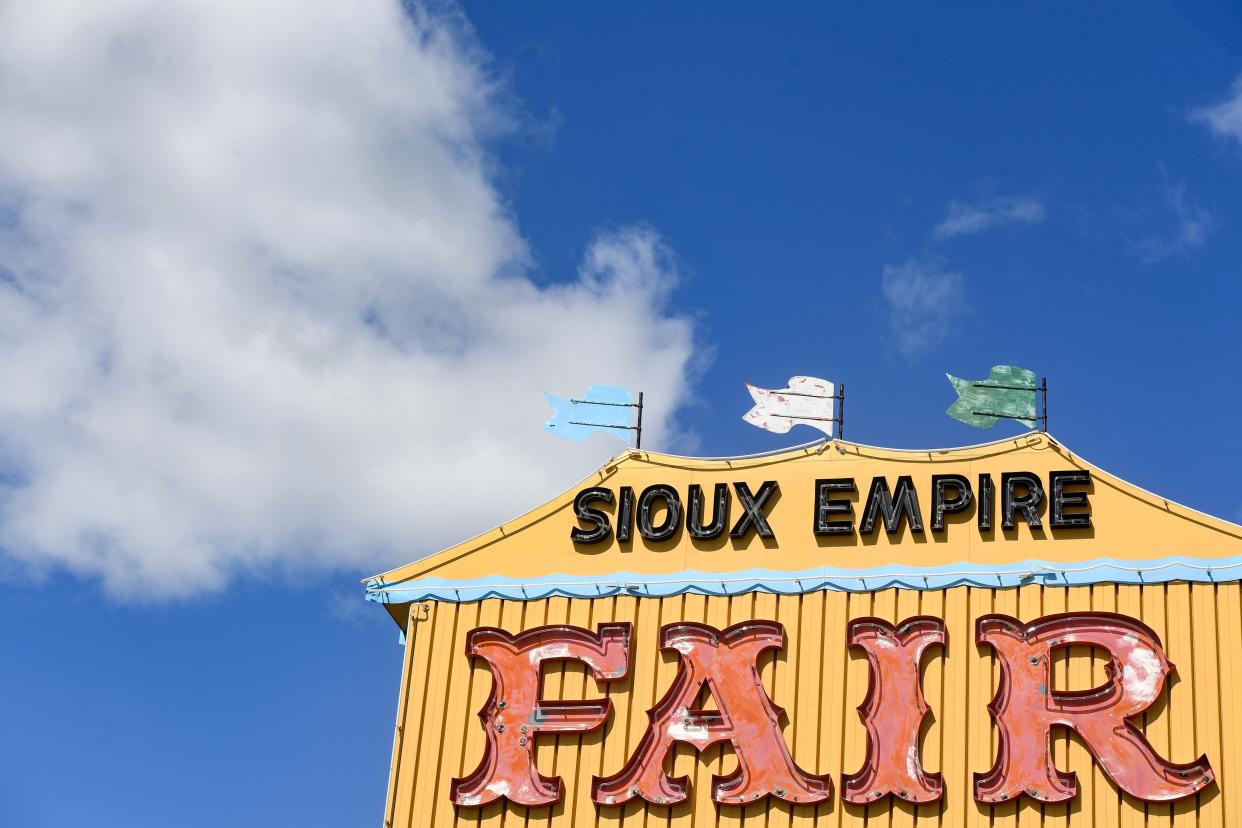 A metal sign for the Sioux Empire Fair stands against a blue sky at the entrance to the W.H. Lyons Fairgrounds on Thursday, July 28, 2022, in Sioux Falls.