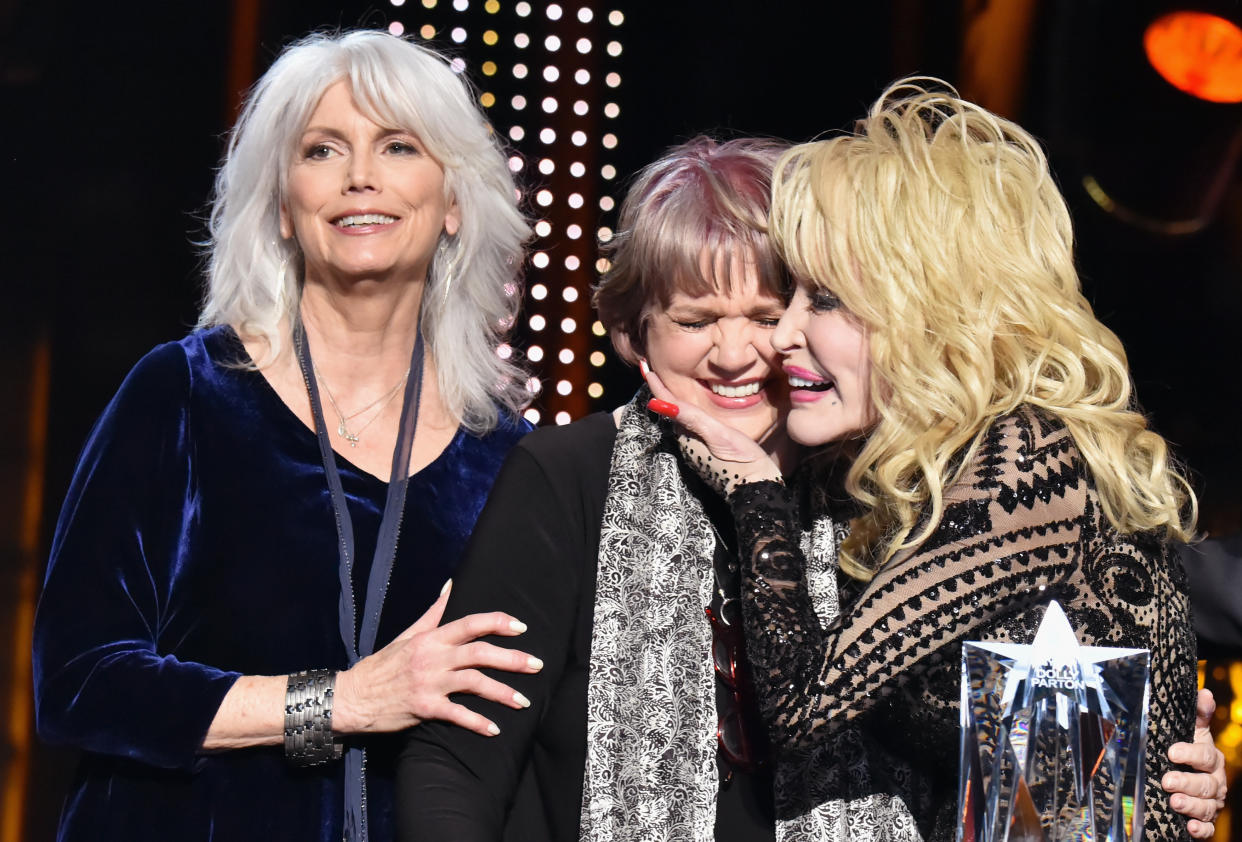 Emmylou Harris, Linda Ronstadt and Dolly Parton onstage at the MusiCares Person of the Year gala on Feb. 8, 2019, in Los Angeles. (Photo: Getty Images)