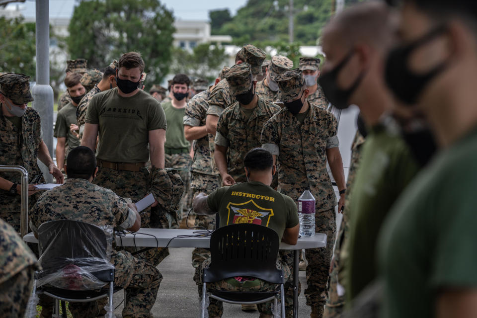 U.S. Marines line up to get the Moderna coronavirus vaccine at Camp Hansen on April 28, 2021 in Kin, Okinawa prefecture, Japan.  / Credit: Carl Court/Getty