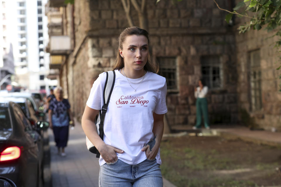 Dziana Maiseyenka, 28, walks in a street in Yerevan, Armenia, Saturday, Sept. 7, 2024, after being denied entry to neighboring Georgia because an arrest warrant had been issued for her by authorities in Minsk. (Hayk Baghdasaryan/Photolurey via AP)