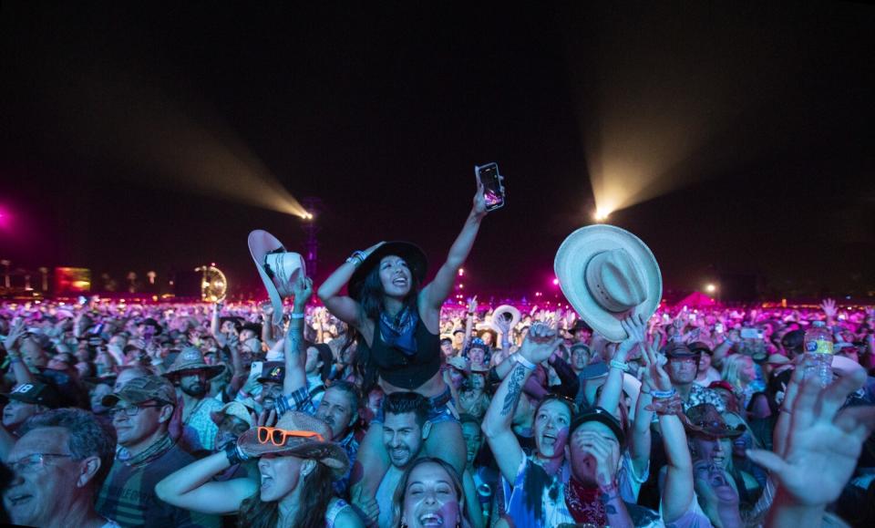 Fans cheer as they watch Sunday headliner Luke Combs.