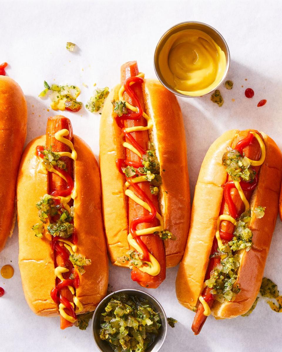 carrots in a hotdog bun with mustard, ketchup, and relish