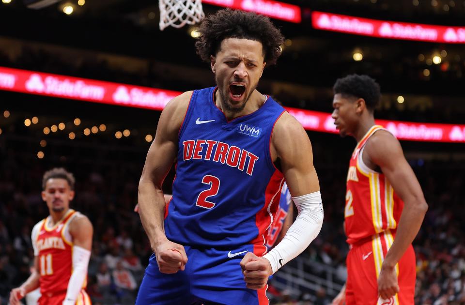 Pistons guard Cade Cunningham reacts as he draws a foul after dunking against Hawks guard Trae Young during the fourth quarter of the Pistons' 130-124 loss on Monday, Dec. 18, 2023, in Atlanta.
