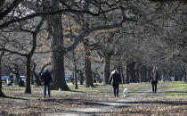 Residents exercise at Hagley Park in Christchurch, New Zealand, Sunday, Aug. 9, 2020. New Zealand on Sunday marked 100 days since it stamped out the spread of the coronavirus, a rare bright spot in a world that continues to be ravaged by the disease. (AP Photo/Mark Baker)