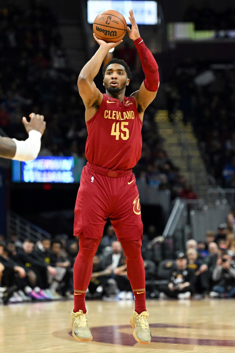 Cleveland Cavaliers guard Donovan Mitchell shoots a 3-point basket during the second half of an NBA basketball game against the Utah Jazz, Monday, Dec. 19, 2022, in Cleveland. (AP Photo/Nick Cammett)