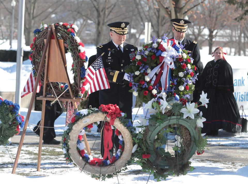 Brig. Gen. Jake S. Kwon, left, on behalf of President Joe Biden, and Maj. Timothy Paroz, salute the bust of President William McKinley at the annual wreath-laying ceremony Saturday honoring the birthday of the 25th U.S. president.