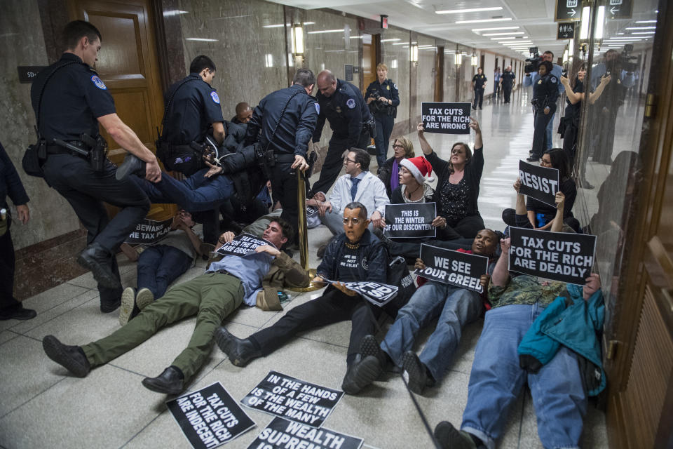 <p>Protesters disrupt the Senate Budget Committee markup of the tax reform bill in Dirksen Building on Nov. 28, 2017. (Photo: Tom Williams/CQ Roll Call/Getty Images) </p>