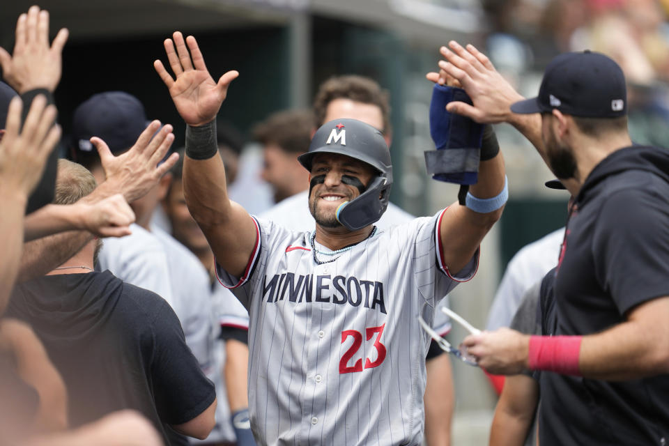 Minnesota Twins' Royce Lewis (23) celebrates scoring against the Detroit Tigers in the 10th inning of a baseball game, Sunday, June 25, 2023, in Detroit. (AP Photo/Paul Sancya)
