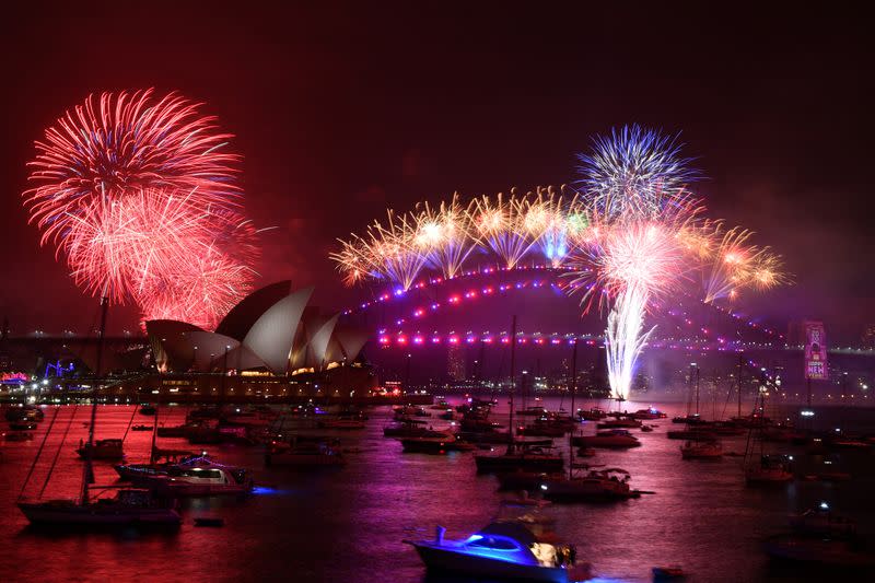 The midnight fireworks are seen from Mrs Macquarie's Chair during New Year's Eve celebrations in Sydney