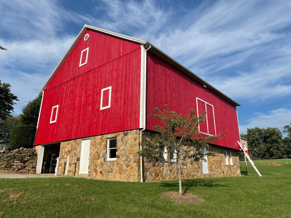 The Millers paint one side of their old red barn each year.