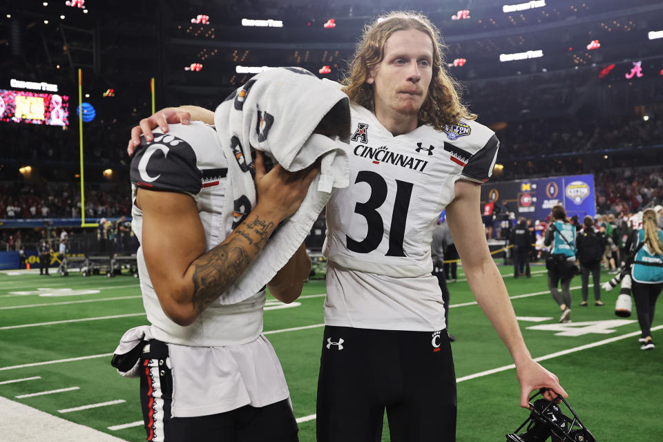 Blue Smith of the Cincinnati Bearcats and Mason Fletcher of the Cincinnati Bearcats react after losing to the Alabama Crimson Tide 27-6 in the Goodyear Cotton Bowl Classic for the College Football Playoff semifinal game at AT&T Stadium.