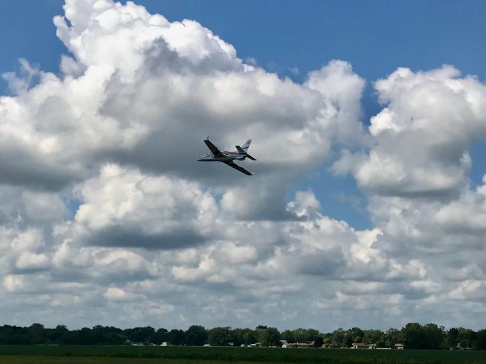 A model jet soars through the sky above Custer Airport.