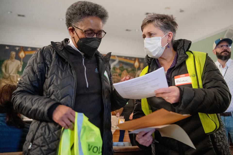 Asheville City Manager Debra Campbell, left, and Melanie Robertson review paperwork while volunteering for the annual point in time count January 31, 2023.