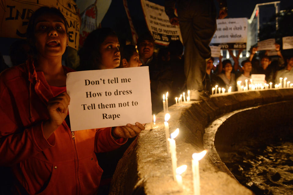 Indian protesters hold candles and posters  during a rally in Ahmedabad on December 30, 2012, following following the cremation of a gangrape victim in the Indian capital. (SAM PANTHAKY/AFP/Getty Images)