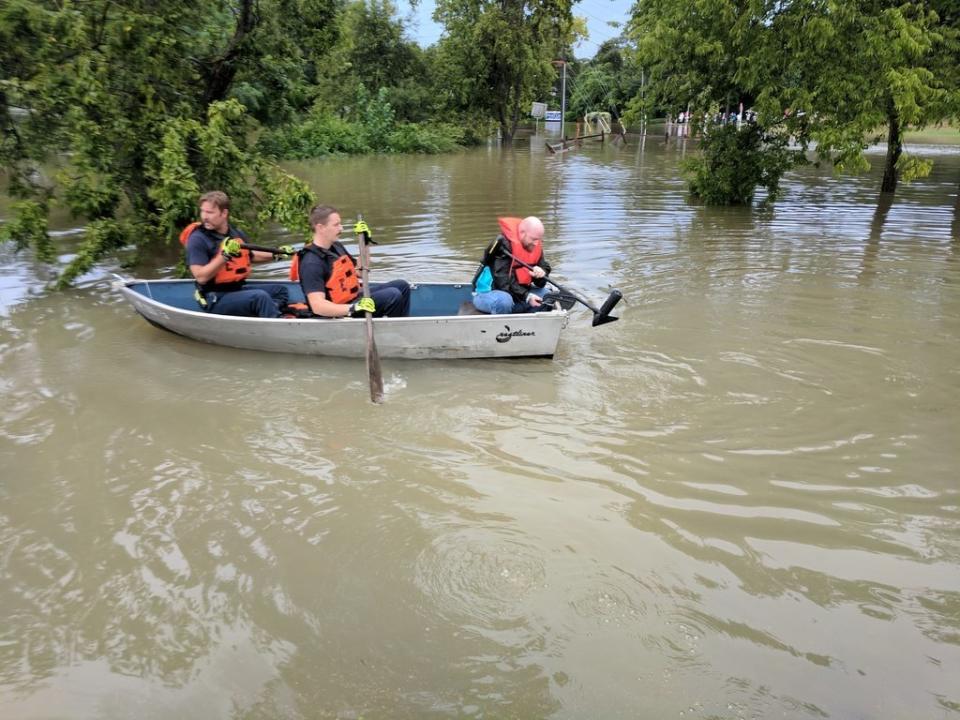 People in a boat&nbsp;following this weekend's heavy rain.