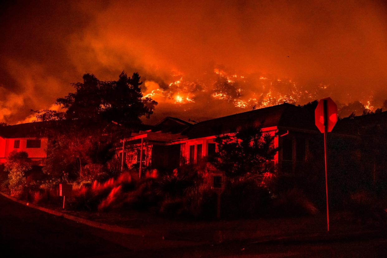 Wildfires seen on the hillside behind homes in Santa Rosa, California
