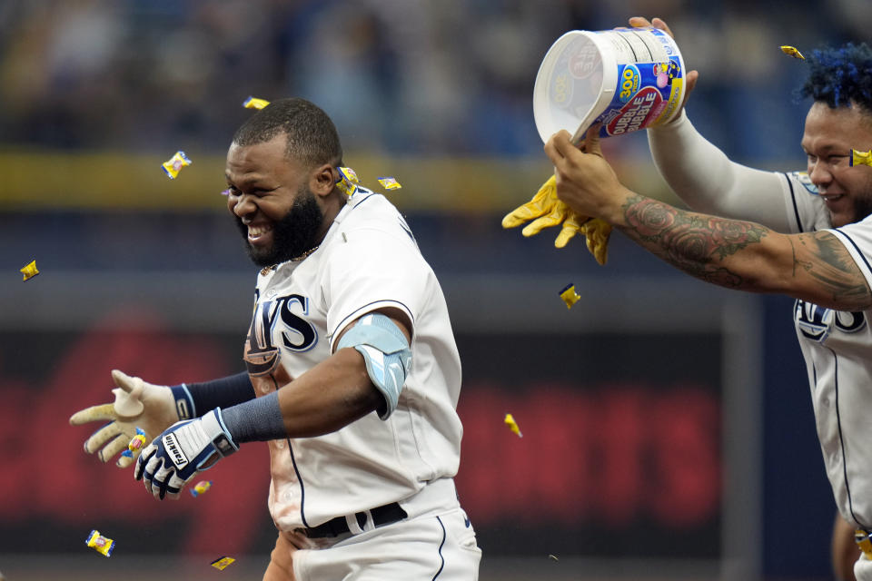 Tampa Bay Rays' Manuel Margot gets covered with gum by Harold Ramirez, right, after Margot hit a walk-off single off Los Angeles Angels relief pitcher Carlos Estevez during the ninth inning of a baseball game Thursday, Sept. 21, 2023, in St. Petersburg, Fla. (AP Photo/Chris O'Meara)