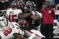 Atlanta Falcons running back Cordarrelle Patterson (84) is hit by a host of Tampa Bay Buccaneers defenders during the first half of an NFL football game, Sunday, Dec. 5, 2021, in Atlanta. (AP Photo/Brynn Anderson)