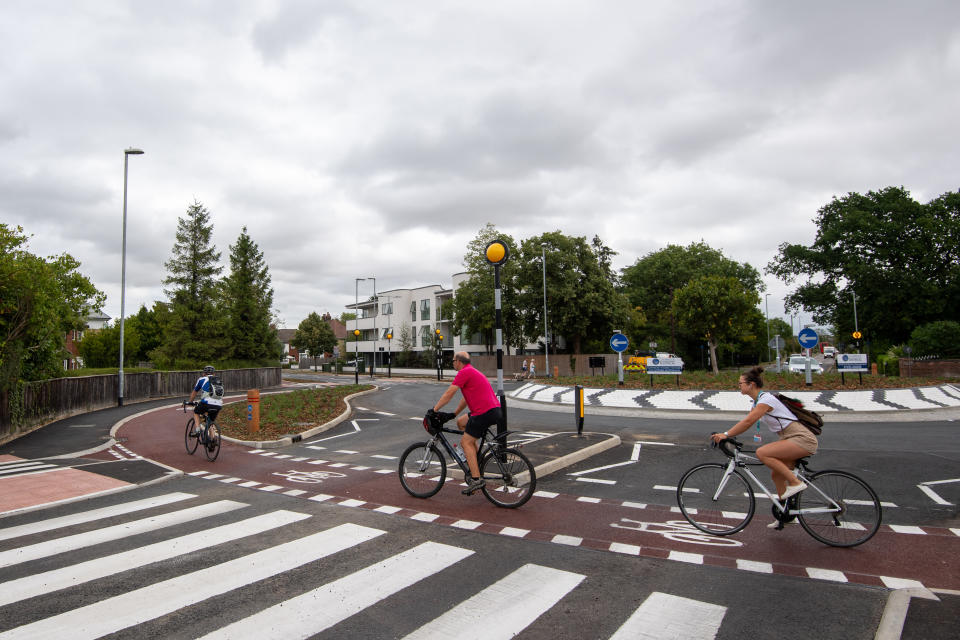 Cyclists use the UK's first Dutch-style roundabout � which prioritises cyclists and pedestrians over motorists � after it opened in Fendon Road, Cambridge. The cost of the scheme, originally estimated at around GBP 800,000, has almost trebled to GBP 2.3m at the end of the project.