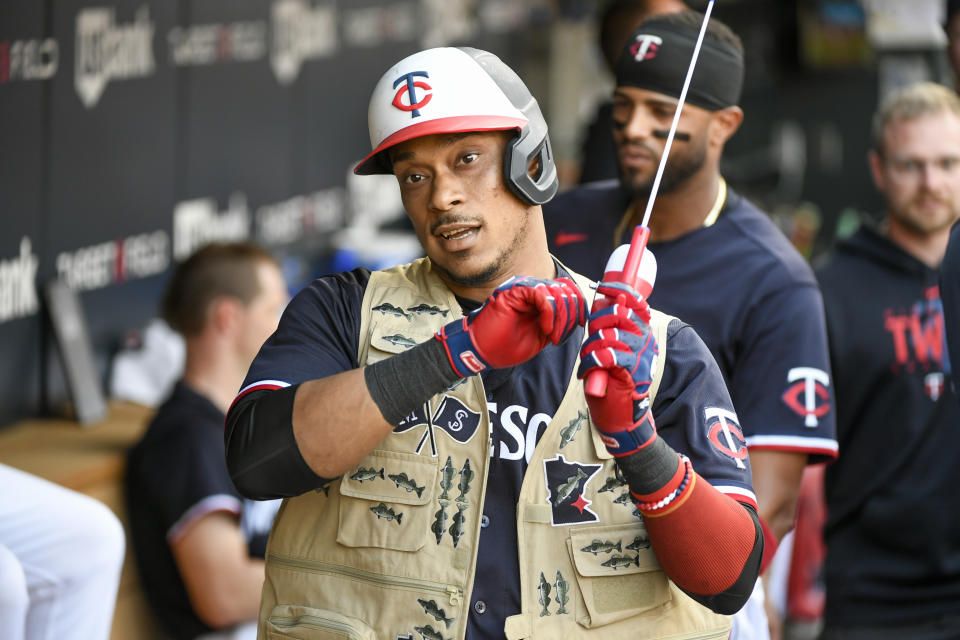 Minnesota Twins' Jorge Polanco puts on a home run celebration fishing vest after hitting a home run against Cleveland Guardians pitcher Logan Allen during the first inning of a baseball game, Saturday, June 3, 2023, in Minneapolis. (AP Photo/Craig Lassig)