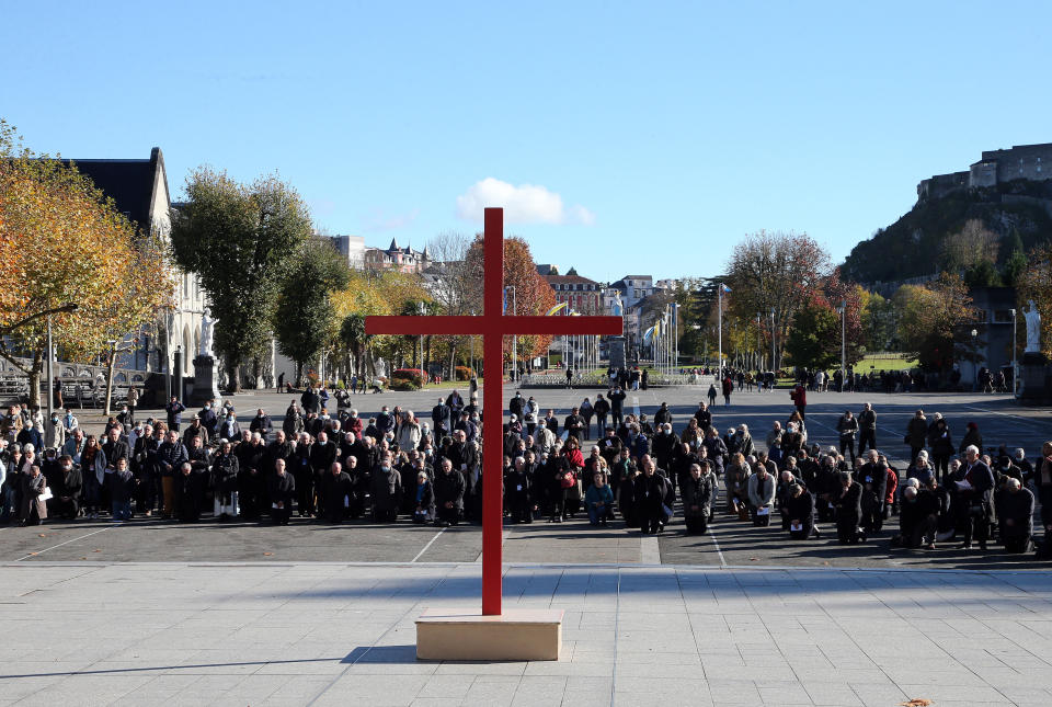 FILE - Bishops kneel on the forecourt of the Notre-Dame-du-Rosaire basilica in the sanctuary of Lourdes, southwestern France, Saturday, Nov. 6, 2021 during a ceremony, part of The Bishops' Conference. The head of the Independent National Authority for Recognition and Reparation said Thursday March 9, 2023 that over 1,180 victims have come forward to claim compensation since the body was established, including 32% of women and 68% of men. (AP Photo/Bob Edme, File)