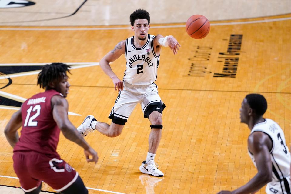 Vanderbilt guard Scotty Pippen Jr. (2) passes the ball away from South Carolina's Trae Hannibal (12) in the first half of an NCAA college basketball game Saturday, Jan. 30, 2021, in Nashville, Tenn.