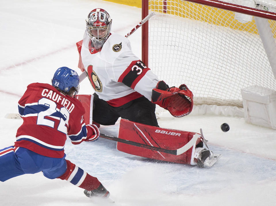 FILE - In this May 1, 2021, file photo, Montreal Canadiens' Cole Caufield scores against Ottawa Senators' goaltender Filip Gustavsson during overtime of an NHL hockey game in Montreal. Caufield was dominating college hockey in late March and by late May was a regular in the lineup of the most storied franchise in the NHL, helping the Canadiens advance to the third round of the playoffs. (Graham Hughes/The Canadian Press via AP, iIle)