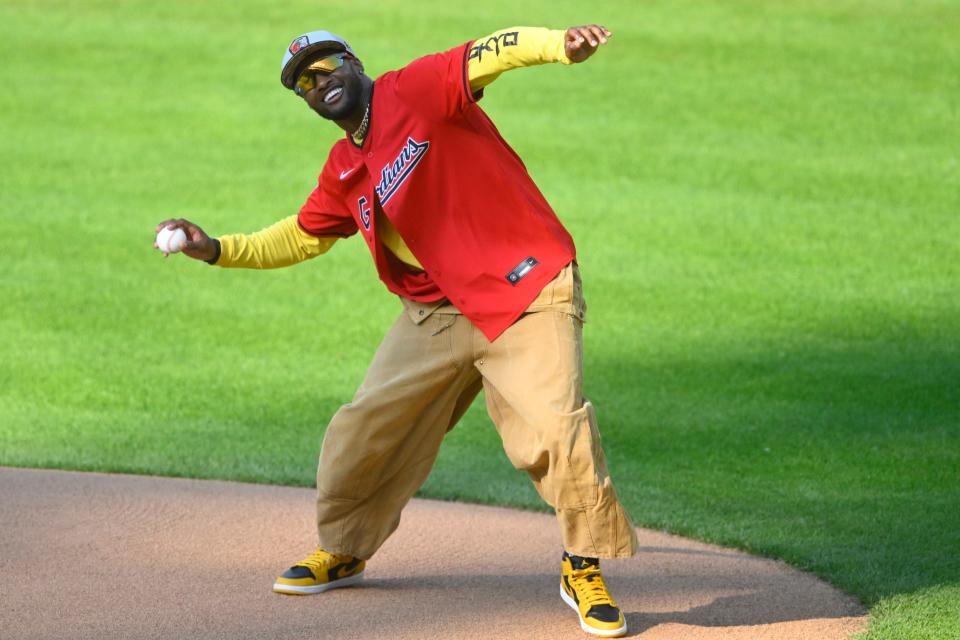 May 21, 2024; Cleveland, Ohio, USA; Cleveland Browns cornerback Denzel Ward throws an autographed baseball to the crowd during a ceremonial first pitch before a game between the Cleveland Guardians and the New York Mets at Progressive Field. Mandatory Credit: David Richard-USA TODAY Sports