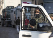 An Indian security officer stands at the site of an attack on the outskirts of Srinagar, Indian controlled Kashmir, Thursday, Nov. 26, 2020. Anti-India rebels in Indian-controlled Kashmir Thursday killed two soldiers in an attack in the disputed region’s main city, the Indian army said.(AP Photo/Mukhtar Khan)