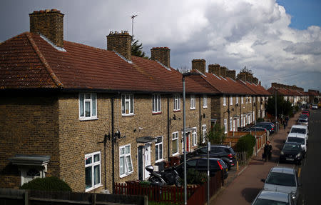 A woman walks along a residential street in Dagenham, east London, Britain, March 18, 2019. REUTERS/Hannah McKay