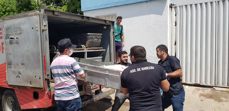 Forensic workers carry a container with a dead body after a shootout between police and bank robbers, in Milagres, Brazil December 7, 2018. REUTERS/Agency Miseria/Normando Sracles